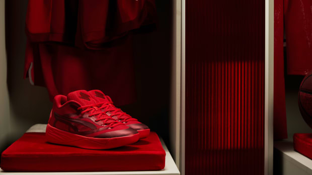 Side view of red Puma basketball shoes.